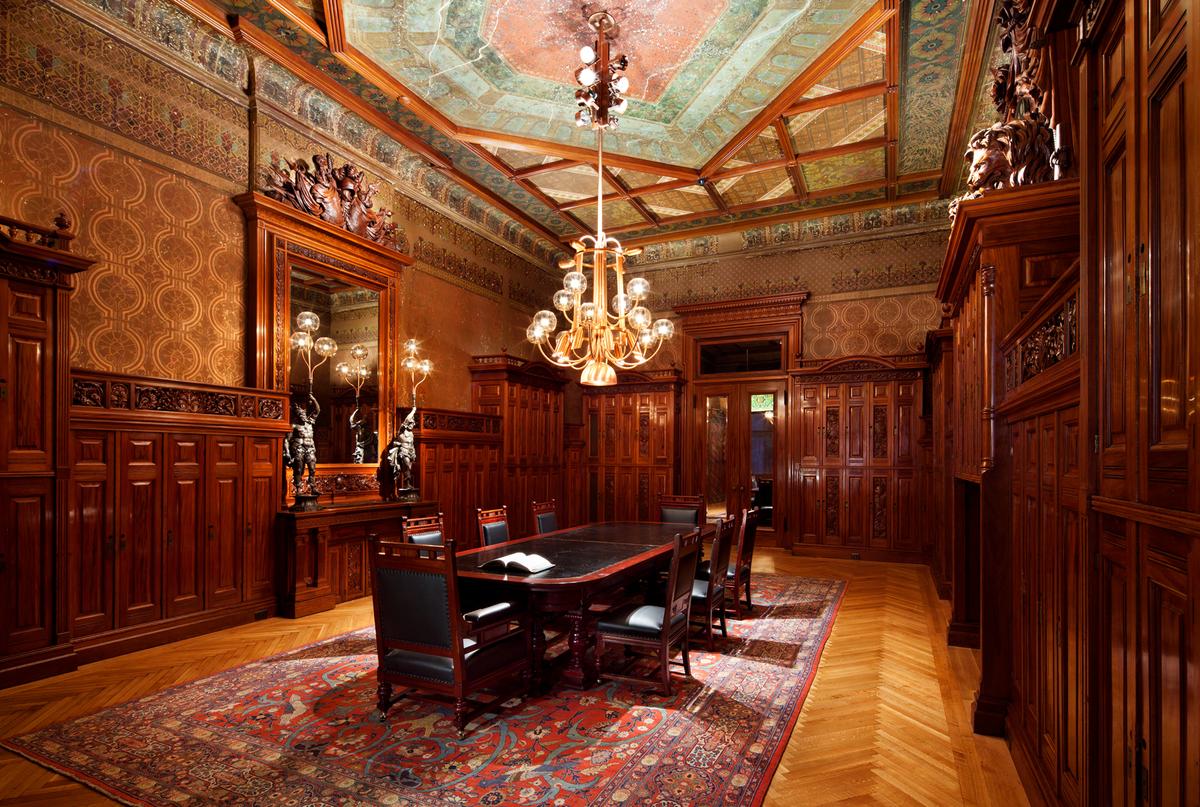 Well-established by the time of their 1880 commission for Company D, Pottier & Stymus was among the country’s leading furniture makers and interior decorators, with clients including titans of industry and the White House. This Renaissance Revival room, restored in 2010, showcases intricately carved mahogany woodwork, a trompe-l'oeil painted ceiling, and walls with terra cotta stencils over a copper field. (James Ewing/Park Avenue Armory)
