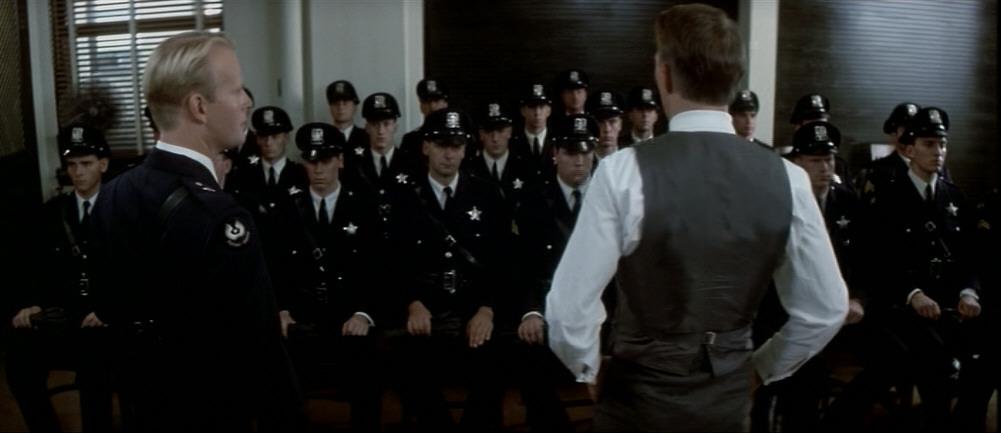 Lt. Anderson (Peter Aylward, L) and Eliot Ness (Kevin Costner) speak to policemen, in “The Untouchables.” (Paramount Pictures)