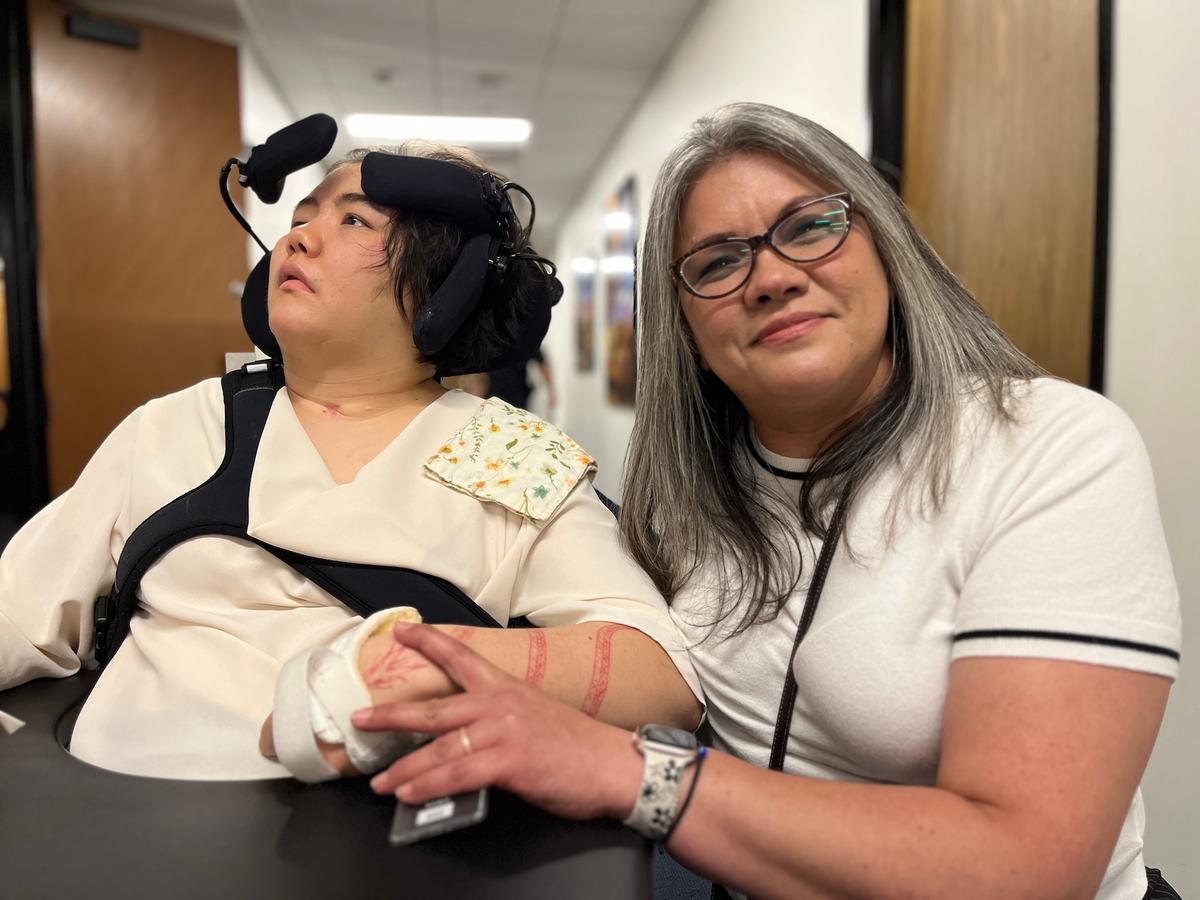 Patti Fox (R), with her daughter Carissa-Aspens, 23, who was left severely injured after being struck by an illegal immigrant driver in 2022. (Allan Stein/The Epoch Times)