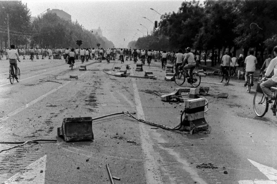 Burned vehicles, toppled barricades, and bloodstains on the ground during and after the suppression of the pro-democracy Tiananmen Square protests in Beijing in June 1989. (Provided to The Epoch Times)