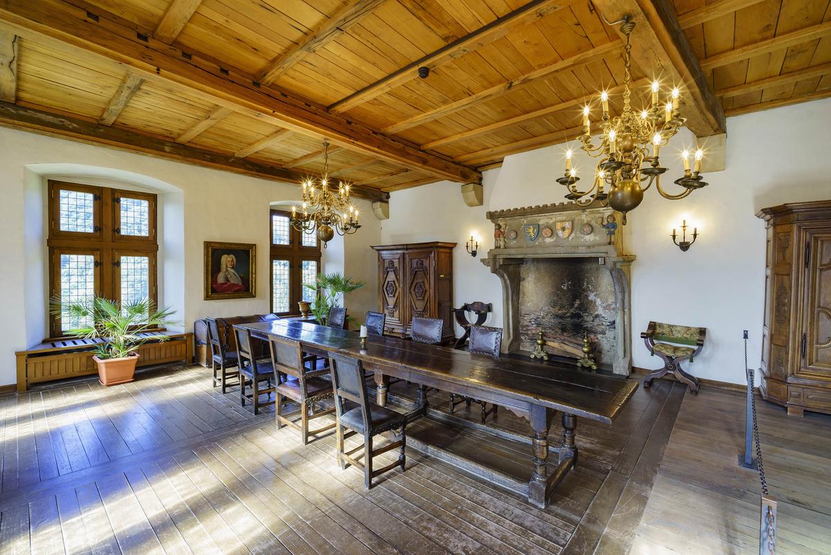 Referred to as the Banqueting Hall, the room was used for dining and entertaining and is furnished with carved, hardwood furnishings crafted from the 17th to 19th centuries. The wood-beam ceiling and wood floor are in the Renaissance architectural style. Decorative emblems representing the House of Nassau are embedded in the stone fireplace. (Kit Leong/Shutterstock)