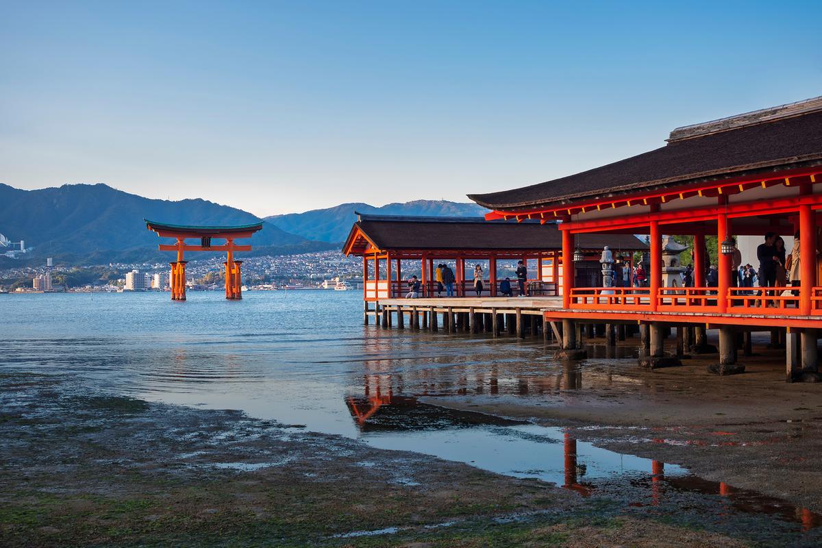 Itsukushima Shrine was built on piers over the water to compensate for the tides. At high tide, the red Otorii gate appears to float on the waters of Hiroshima Bay. (VTT Studio/Shutterstock)