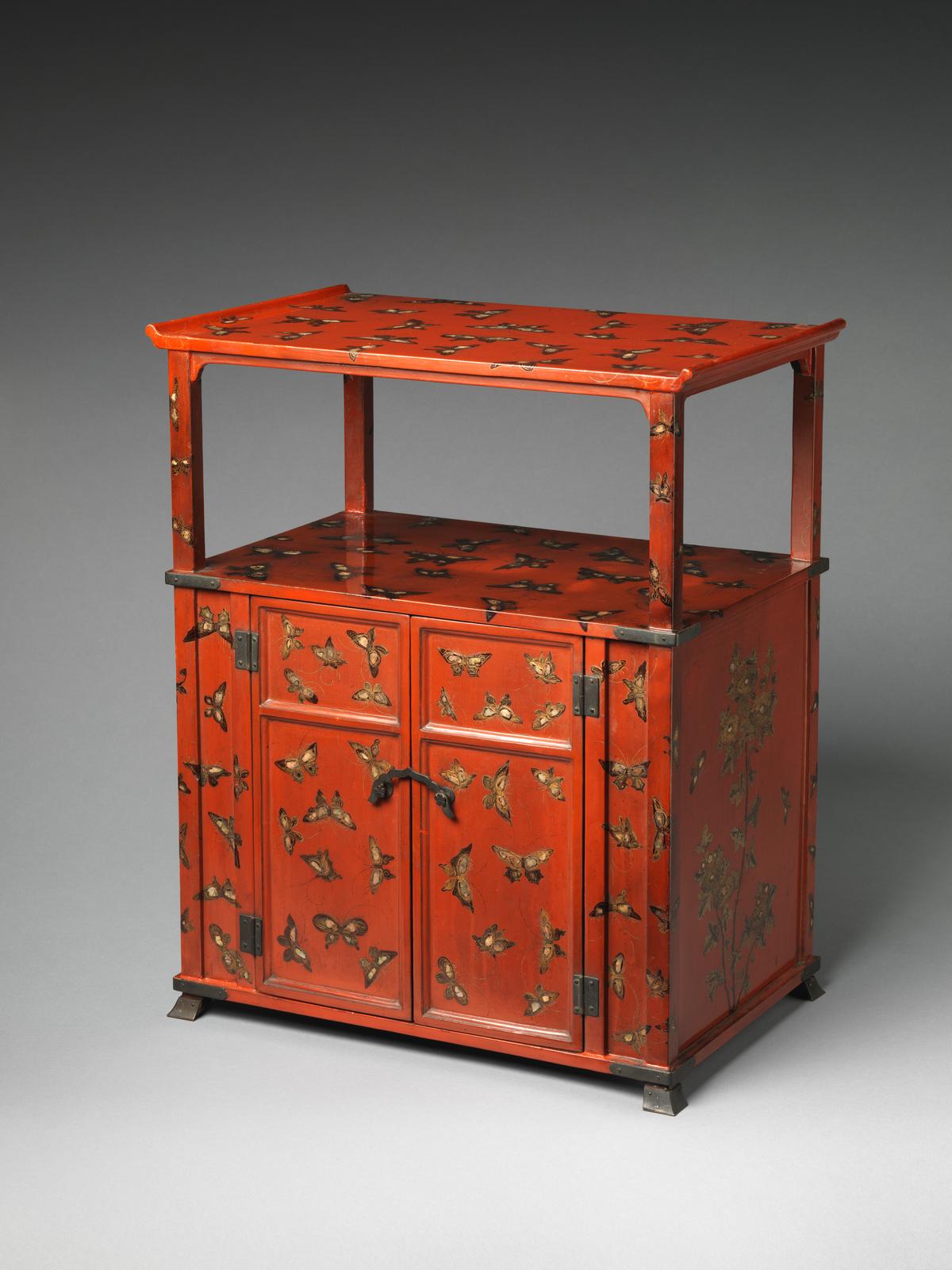 Cabinet with a design of butterflies, 18th century, from Japan's Edo period. Red lacquer with painted decoration, inlaid with mother-of-pearl; 20 1/8 inches by 16 1/2 inches by 10 3/8 inches. The butterflies on this lacquer cabinet don't sit still: Layered in colored lacquer and mother-of-pearl, they shift and shimmer as the light moves across them. Metropolitan Museum of Art, New York City. (Public Domain)