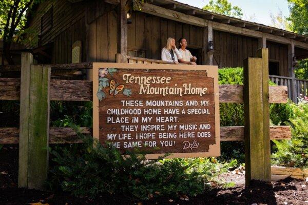 The "Tennessee Mountain Home" plaque bearing Dolly Parton's signature marks the replica of her childhood home. (Dollywood Parks & Resorts)