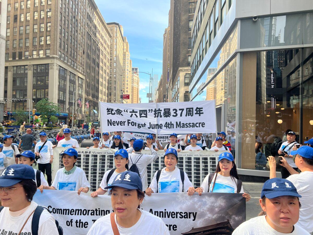 Members of the New York branch of the China Democracy Party march in Midtown Manhattan on June 2, 2026, to mark the 37th anniversary of the Tiananmen Square massacre. (Shiping/The Epoch Times)