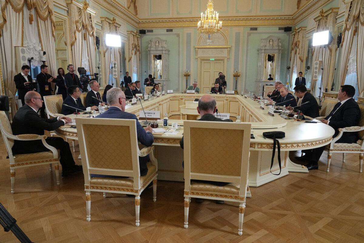 Russian President Vladimir Putin (background 3rd R) meets with representatives of international news agencies on the sidelines of the St. Petersburg International Economic Forum at the Constantine Palace in St. Petersburg, Russia, on June 4, 2026. (Dmitri Lovetsky/AP Photo)