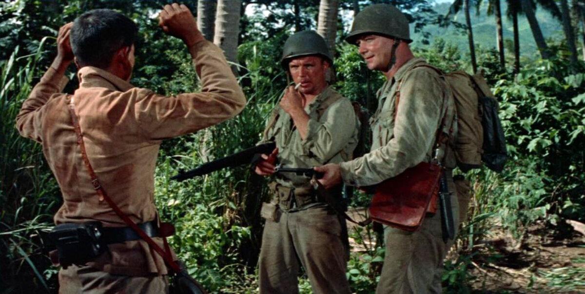 (L–R) A Japanese prisoner of war (Robert Hosai), Gallagher (Richard Jaeckel), and Sgt. Sam Croft (Aldo Ray), in “The Naked and the Dead.” (RKO Radio Pictures)