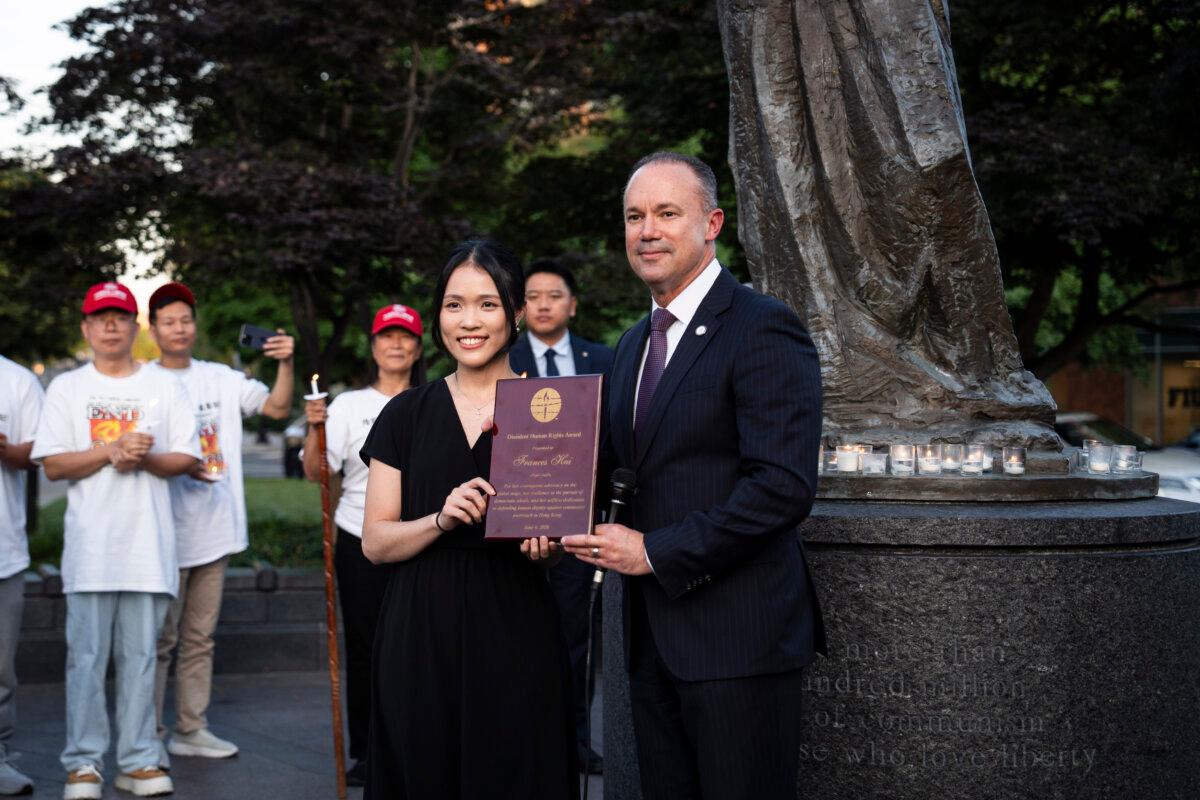 Frances Hui, policy and advocacy coordinator of the Committee for Freedom in Hong Kong Foundation, receives a dissident human rights award during the Tiananmen Square massacre candlelight vigil held at the Victims of Communism Memorial in Washington on June 4, 2026. (Madalina Kilroy/The Epoch Times)
