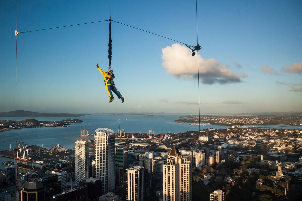 A man experiences the SkyJump from the Sky Tower, descending hundreds of feet in a controlled fall. (Conchi Martínez/Getty Images)