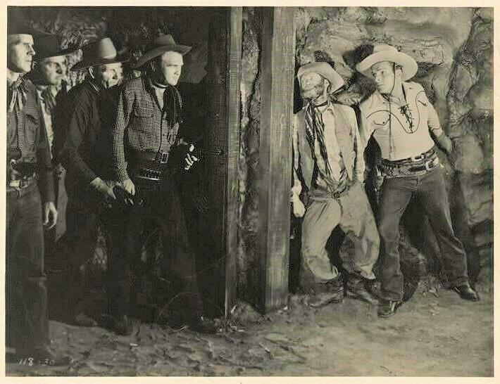 (L–R) The gang of robbers faces off with Fuzzy Jones (Al St. John) and Billy Carson (Buster Crabbe), in “Wild Horse Phantom.” (GJW+)