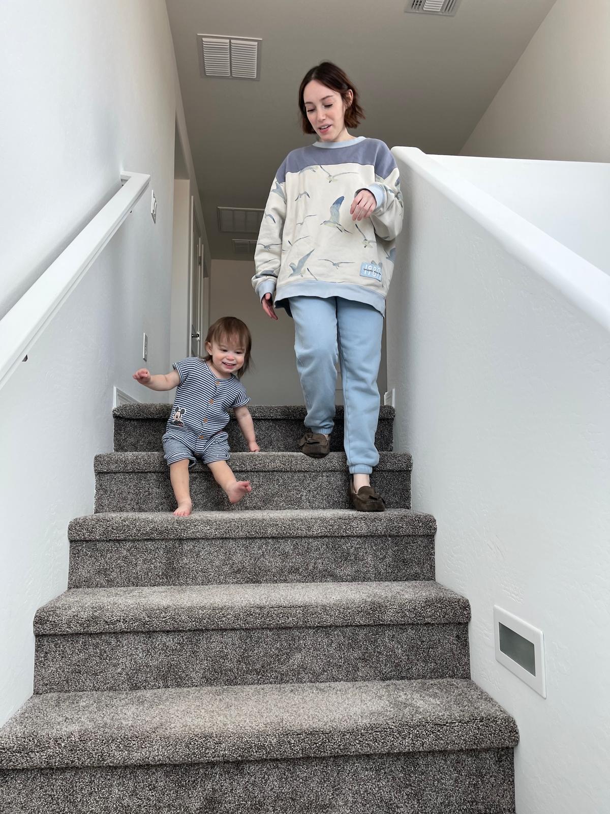 Annabelle Mattaliano (R) and her son Fox walk down the stairs of their new home in Avondale, Ariz., on June 6, 2026. (Allan Stein/The Epoch Times)