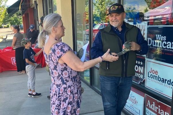 Nevada Second Congressional District GOP candidate David Flippo signs a hat for a voter during a June 6 campaign meet-and-greet at the Washoe County Republican Party offices in Reno in the final weekend pitch before the state’s June 9 primaries. (John Haughey/The Epoch Times)