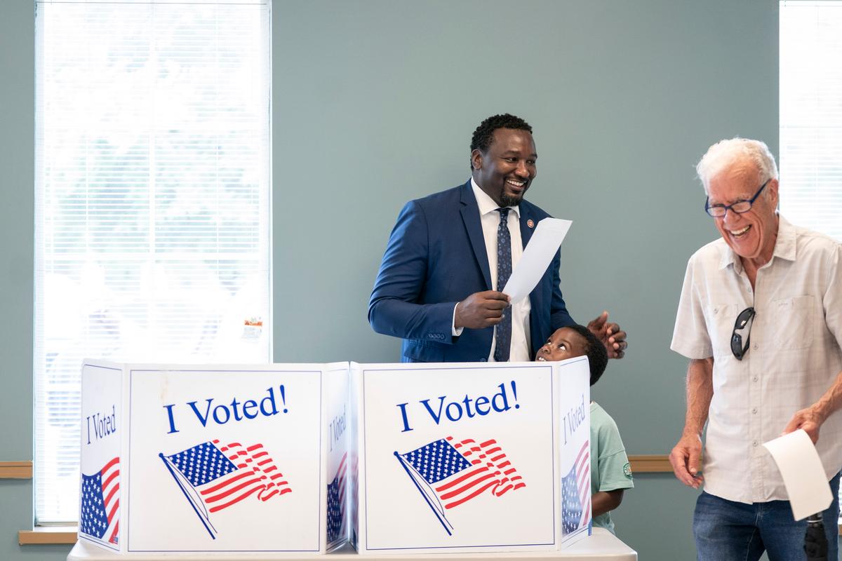 Gubernatorial candidate Rep. Jermaine Johnson (D-Richland), left, accompanied by his son, Kobe, shares a laugh after completing a ballot during early voting at the Garners Ferry Adult Activity Center in Hopkins, South Carolina on May 26, 2026. (Sean Rayford/Getty Images)