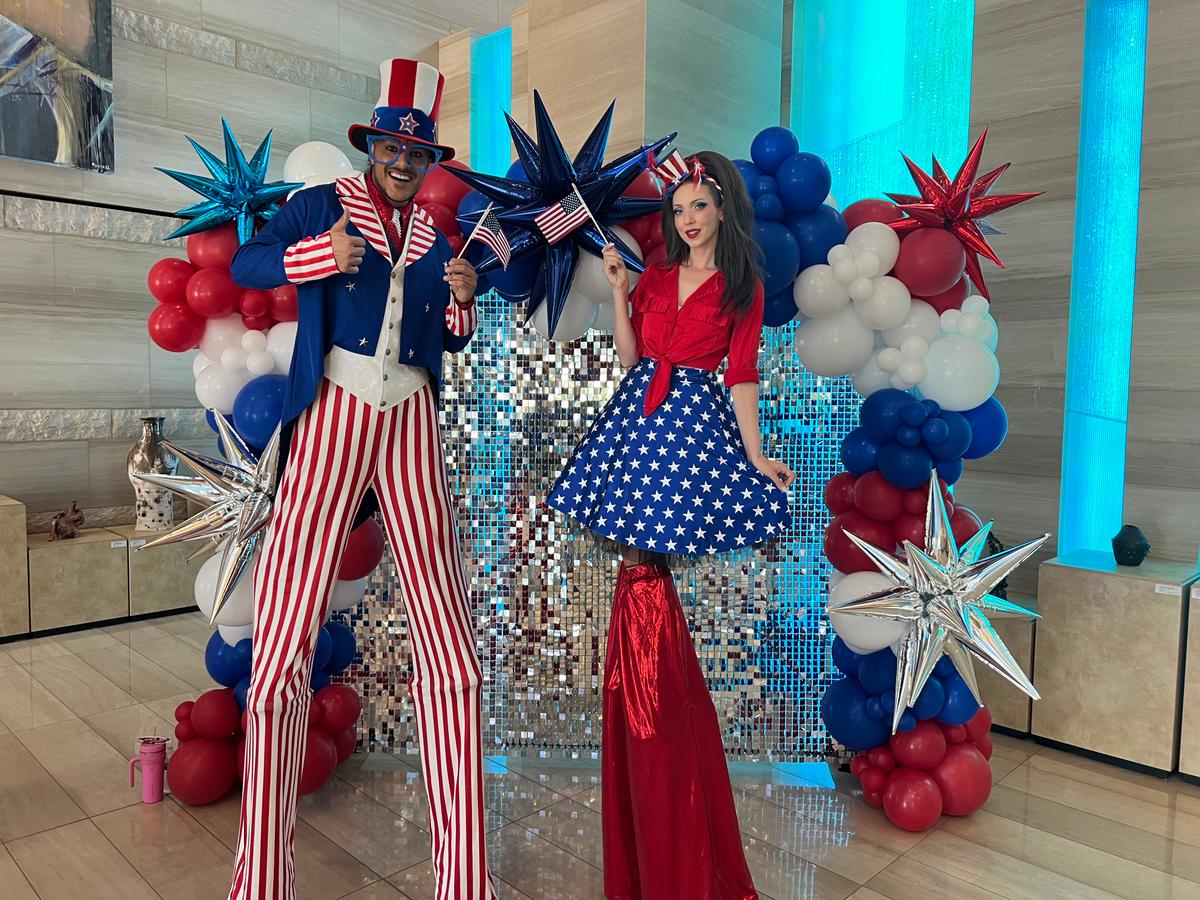 Patriotic stilt-walkers Jeffrey DeBarathy and Sarah Roberts greeted voters at the Las Vegas City Hall during the primary election on June 9, 2026. (Jacki Thrapp/The Epoch Times)