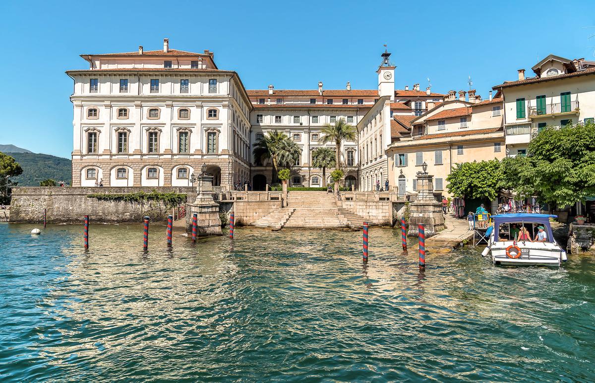 The ferry dock at Isola Bella is adjacent to the Palazzo Borromeo entrance. The distinctive baroque structure features a T-shaped design with a central facade that faces Lake Maggiore to the west. (elesi/Shutterstock)