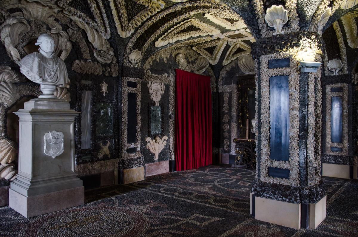 On Palazzo Borromeo’s lower level are six grottoes, which are cool, cave-like rooms where guests could escape warm temperatures. This grotto’s walls, ceiling, floor, and columns are ornately apportioned with a mosaic of shells, marble, pebbles, and volcanic rock pieces. The bust is a member of the House of Borromeo, the influential aristocratic family that originally built the palace. (Shay Yacobinski/Shutterstock)