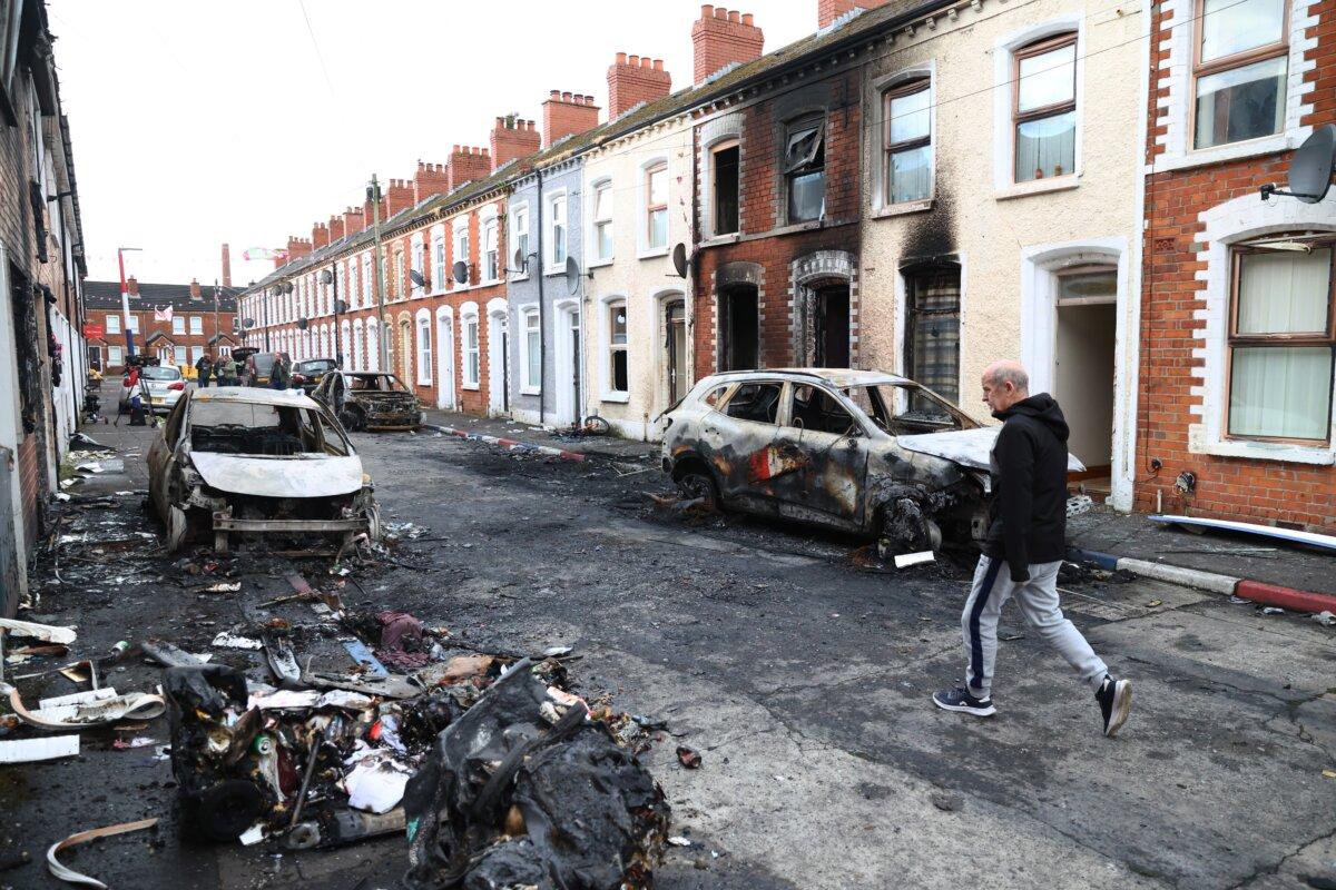 A man walks down a street after rioting broke out late Tuesday following a stabbing incident, in east Belfast, Northern Ireland, on June 10, 2026. (Peter Morrison/AP Photo)