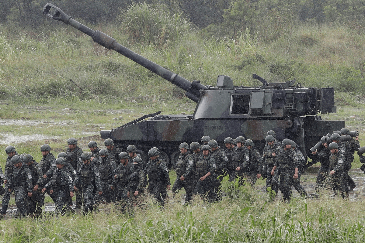 Soldiers move past a self-propelled howitzer during military live-fire training in Taichung City, Taiwan, on June 9, 2026. (Chiang Ying-ying/AP Photo)