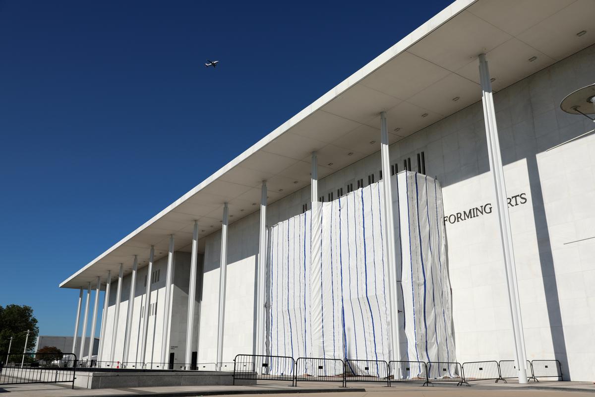 The wall of the John F. Kennedy Center for the Performing Arts is covered in tarp as work continues on the removal of President Donald Trump's name in Washington on June 13, 2026. (AP Photo/Rahmat Gul)