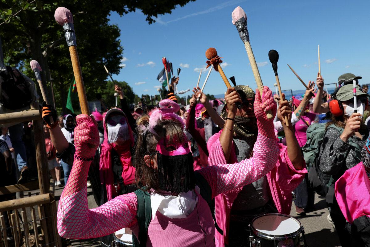 People hold a protest against the G7 summit, in Geneva, Switzerland, on June 14, 2026. (Umit Bektas/Reuters)