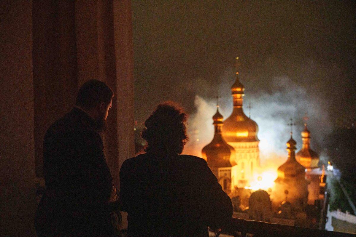 Bishop Avraamiy (R) of the Kyiv-Pechersk Lavra of the Orthodox Church of Ukraine, looks at the burning Dormition Cathedral of Kyiv-Pechersk Lavra, also known as the Monastery of the Caves, during a Russian strike on Kyiv, Ukraine, on June 15, 2026. (Evgeniy Maloletka/AP Photo)