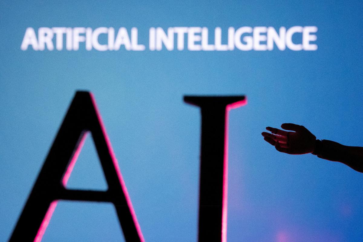A robot hand reaches out to the letters AI (Artificial Intelligence) in an image taken at an undisclosed location on June 23, 2023. (Dado Ruvic/Reuters)