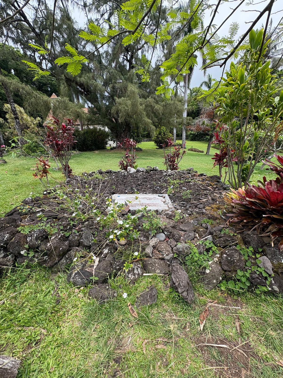 Charles Lindbergh's grave is unassuming, surrounded by foliage in a simple church graveyard in the Hawaiian Islands. (Deena Bouknight)
