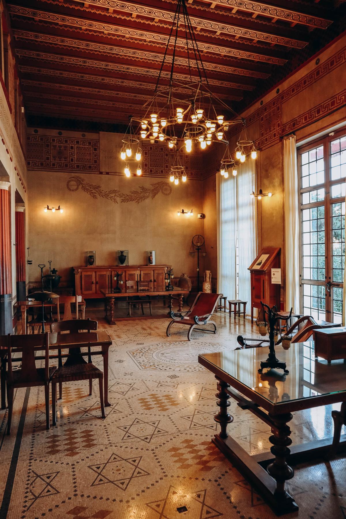 The library, one of the villa’s largest rooms, features books on art and archeology and a collection of objects in oak cabinetry. Emulating the practice of the ancient Greeks, Reinach used two lecterns (one pictured here) for reading and working while standing. The room’s central mosaic shows the Greek goddess Hera and the Titan Prometheus. The bronze lamps on the tables are replicas of lamps at the National Archaeological Museum of Naples, Italy. (Andrei Antipov/Shutterstock)