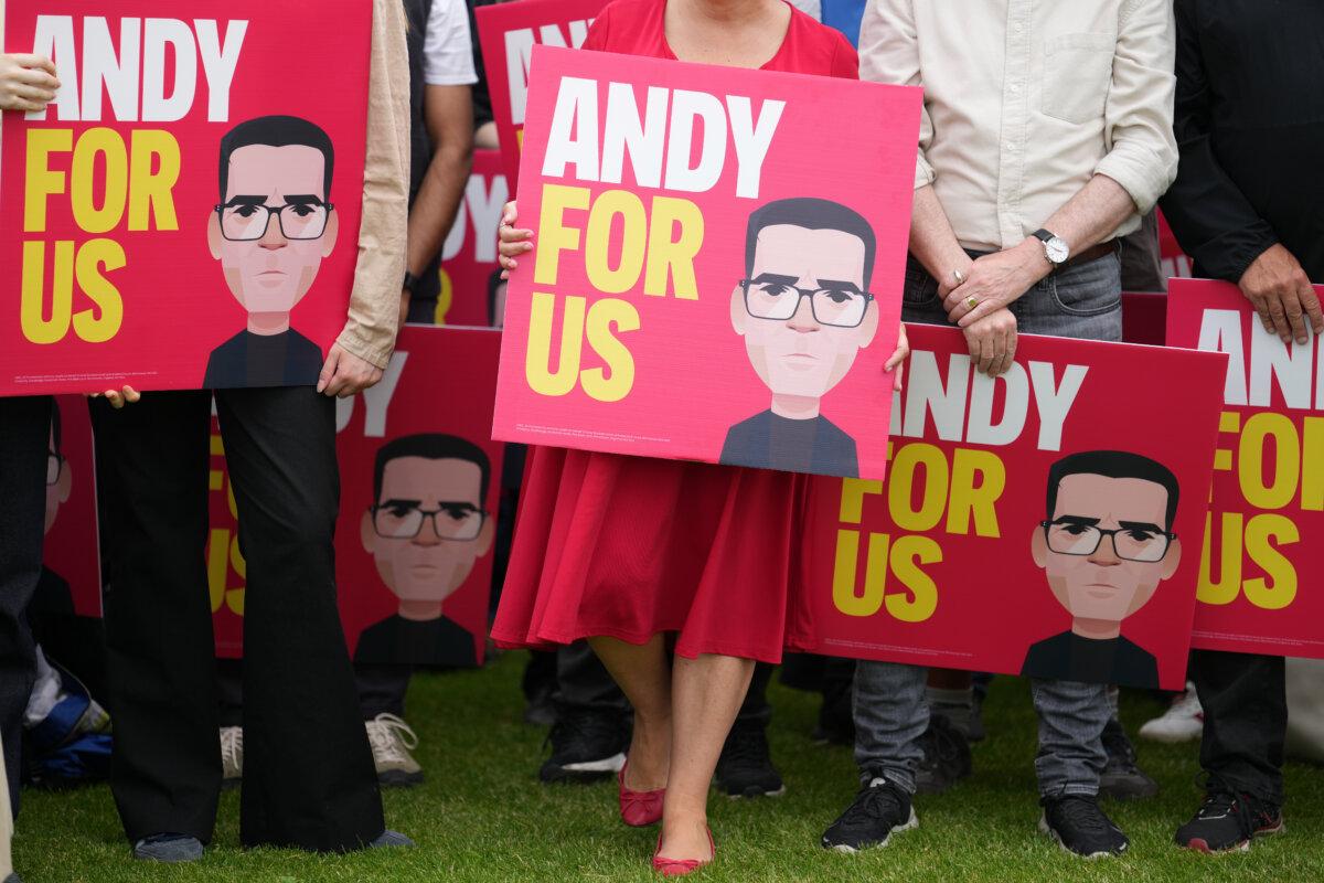 Supporters of the UK's Labour party MP Andy Burnham show placards before his speech after the Makerfield by-election in Wigan, England, on June 19, 2026. (AP Photo/Jon Super)