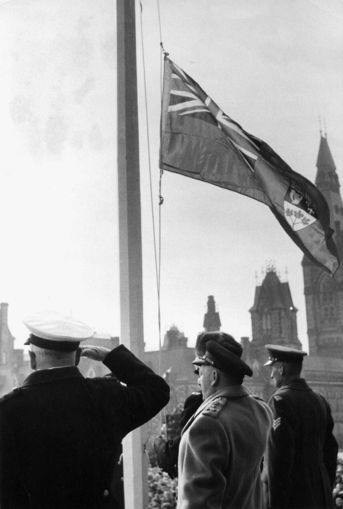 The Red Ensign comes down to make way for Canada's new maple leaf flag at a ceremony on Parliament Hill in Ottawa on Feb. 15, 1965. (Public Domain)