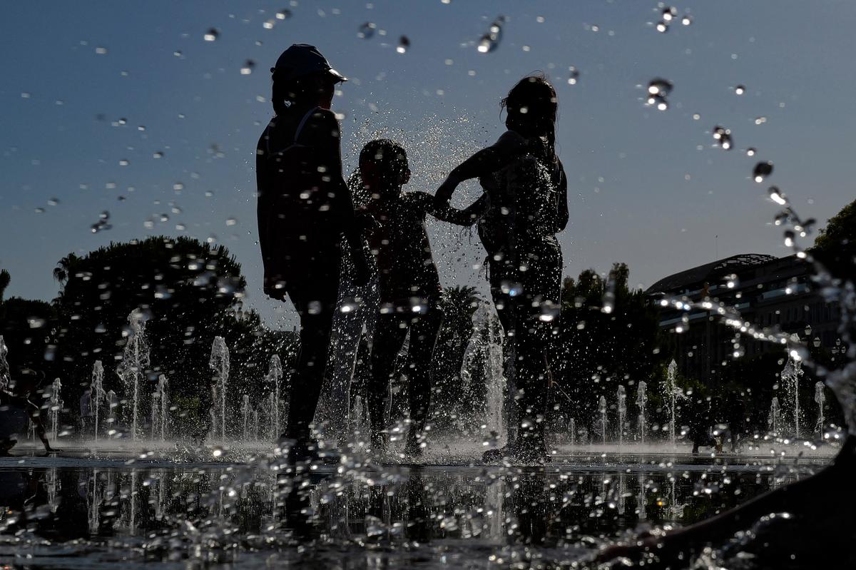 Children play in a water mirror fountain in Nice, a city on the French Riviera, on June 19, 2026. A heatwave has hit France and is set to continue for several days, with temperatures expected to reach up to 40°C in some areas on June 21, the first day of summer. (Valery Hache/AFP via Getty Images)