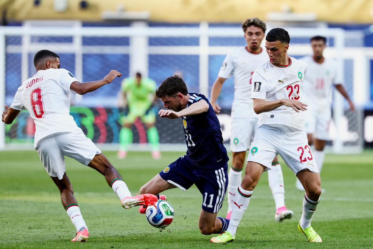 Scotland's forward #11 Ryan Christie, Morocco's midfielders #08 Azzedine Ounahi and #23 Bilal El Khannouss fight for the ball during the 2026 World Cup Group C football match between Scotland and Morocco at the Boston Stadium in Foxborough on June 19, 2026.  (Franck Fife/AFP via Getty Images)