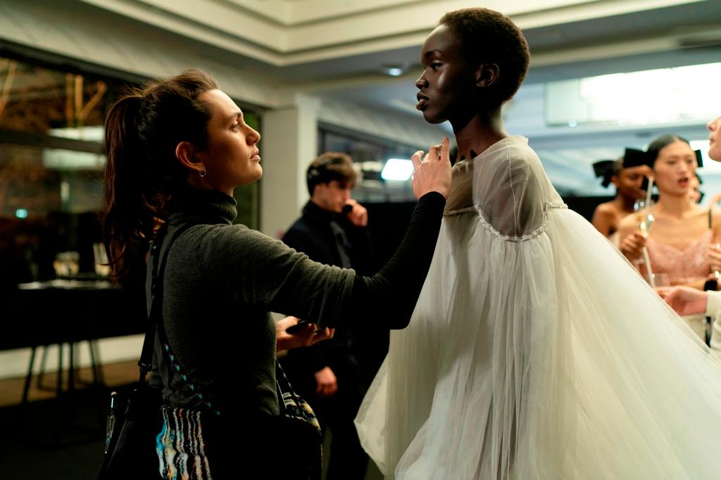 Make-up artist Angele (Ella Rumpf, L) and Ada (Anyier Anei), in "Couture." (Vertical)