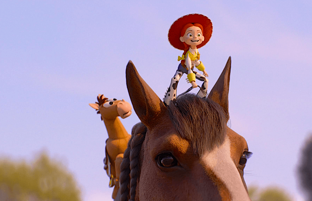 Jessie (voiced by Joan Cusack) and her toy horse companion, Blaze, stand on a real horse's head, in "Toy Story 5." (Walt Disney Studios Motion Pictures)