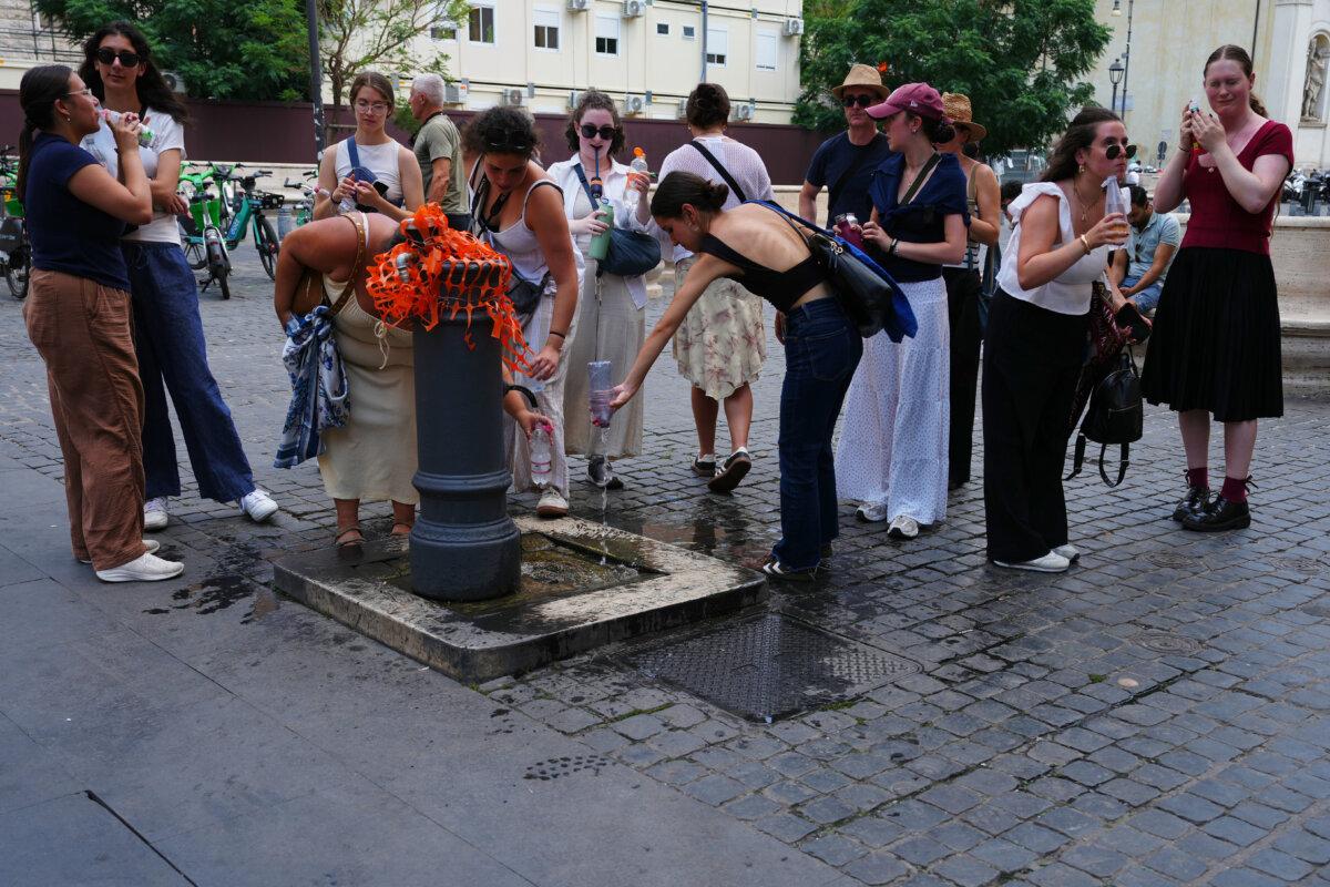 People cool off at a fountain in Rome on June 23, 2026. (Alessandra Tarantino/AP Photo)