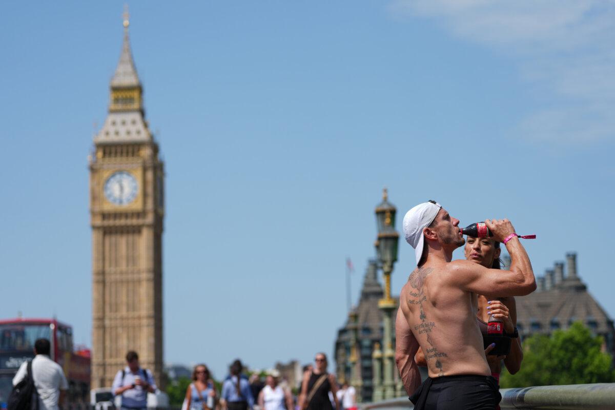 A man drinks on Westminster Bridge as a heat wave engulfs London on June 23, 2026. (Kirsty Wigglesworth/AP Photo)