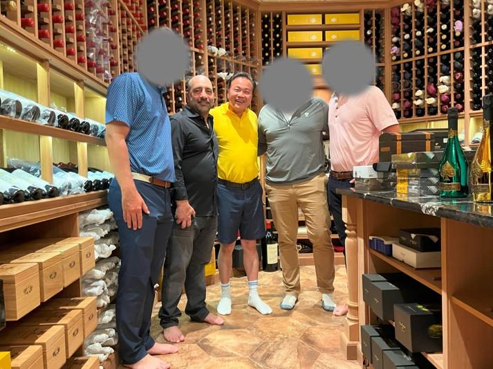 Frank Carone (2nd L) and Yan Po Zhu (C) in a photo from the charges filed against Carone. (U.S. Attorney’s Office for the Eastern District of New York)