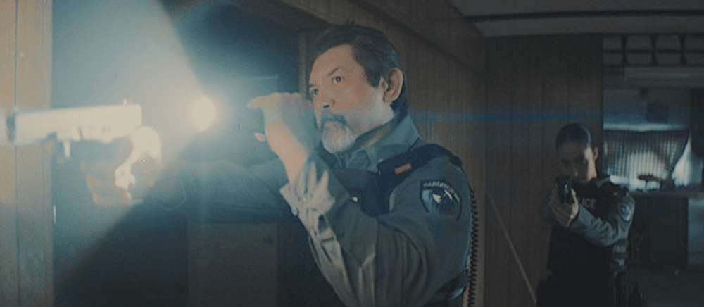 Officers Teddy Sharpe (Lou Diamond Phillips) and Sandra Scala (Dana Namerode) clear a house in "Gangland" (Randomix Productions/Saban Films)