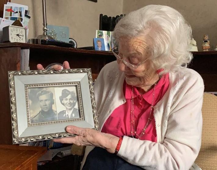 Dutch veteran Sytske Drijber holds a frame featuring photos of her and her late husband, Oscar, from World War II. Oscar escaped from a German prisoner of war camp in 1941 and ended up in Indonesia, where he and Sytske met during intelligence operations for the Netherlands. (Courtesy of Zach Dunn)