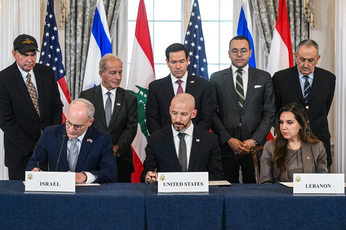 Secretary of State Marco Rubio (C, back row) looks on as (L–R, front row) Israeli Ambassador to the United States Yechiel Leiter, State Department Chief of Staff Daniel Holler, and Lebanese Ambassador to the United States Nada Hamadeh sign a framework agreement at the U.S. Department of State in Washington, on June 26, 2026. (Saul Loeb / AFP via Getty Images)