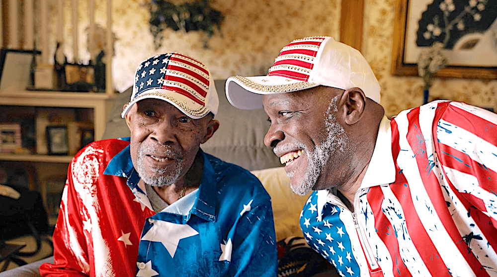 Father and son Albert Brayboy Sr. and Albert Brayboy Jr. being interviewed about what the Flag Day parade means to them, in "Flag Day." (Shea Productions)