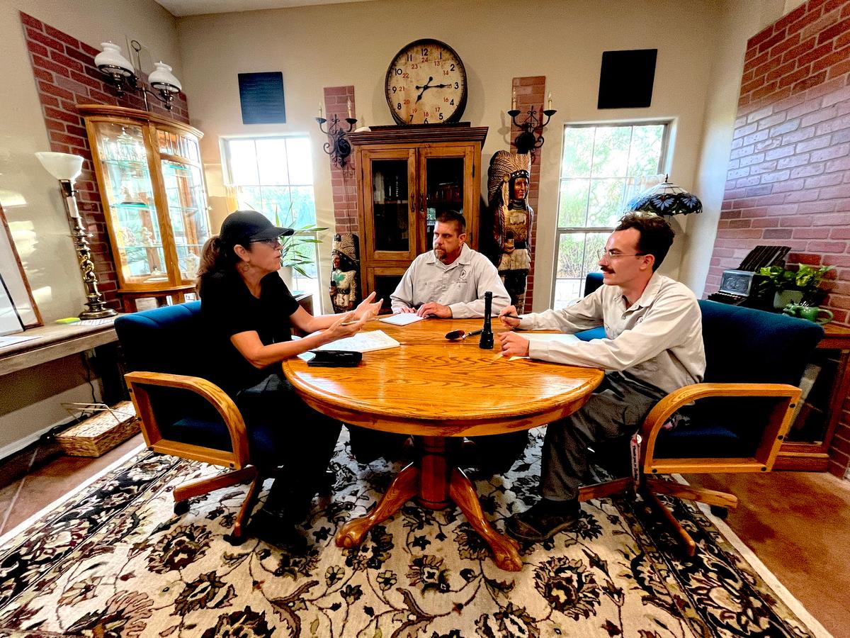 Sealed Out Scorpions founder Georgia Clubb (L), senior scorpion specialist Mike Golleher (C), and pest management operations manager Jeremiah Sourp discuss strategy at their Tempe, Ariz., office on June 24, 2026. (Allan Stein/The Epoch Times)