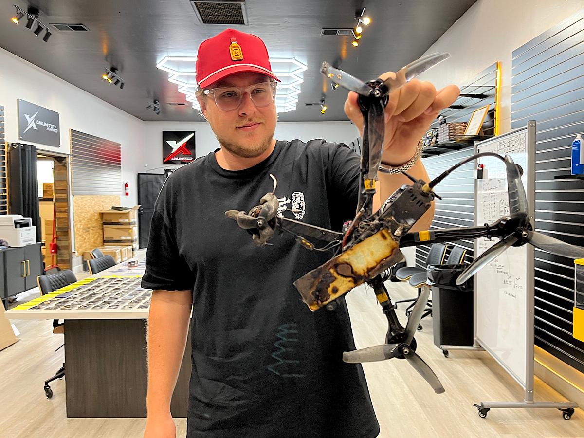 Justin Lawrence, co-founder of Drone Round in Queen Creek, Ariz., displays a small drone that was intercepted and destroyed by a multi-projectile bullet on June 25, 2026. (Allan Stein/The Epoch Times)