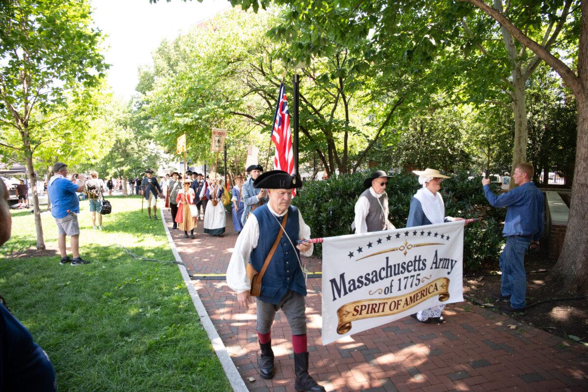 Despite temperatures approaching 100 degrees, thousands of performers and visitors gather at Philadelphia Independence Mall on July 3, 2026, to celebrate America's 250th anniversary. (Larry Dye/The Epoch Times)