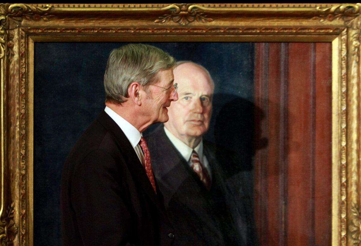 Sen. Michael Meighen walks past the portrait of his grandfather Arthur Meighen, the ninth prime minister of Canada, during an unveiling ceremony on Parliament Hill on Feb. 16, 2011. (The Canadian Press/Fred Chartrand)