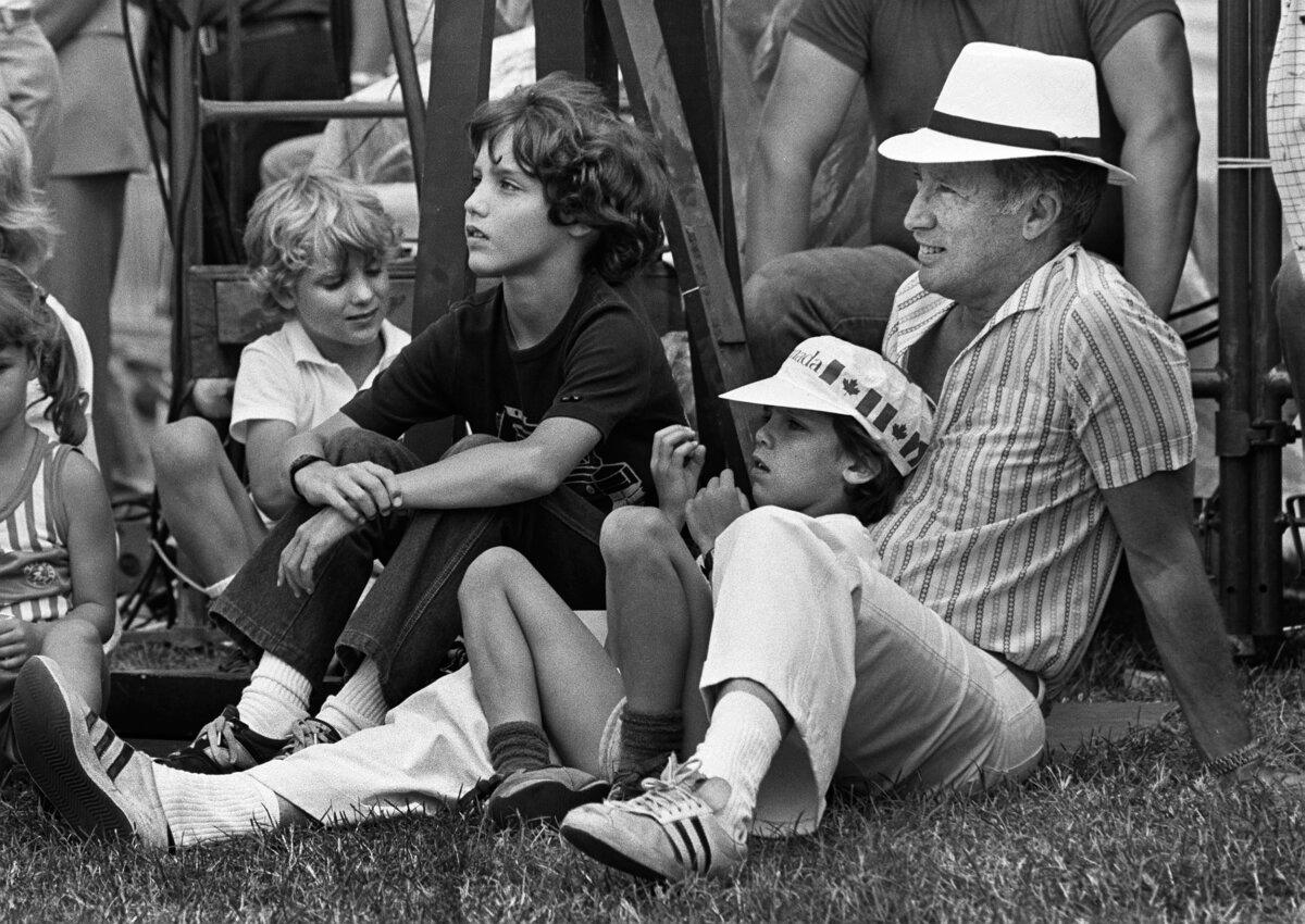 Prime Minister Pierre Trudeau and his sons Alexandre, Justin, and Michel watch the Canada Day ceremonies on Parliament Hill on July 1, 1983. (CP photo/Fred Chartrand)