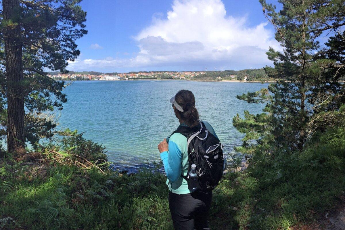 A hiker checks out an intriguing trail with a view to a small Spanish village across the bay. (Photo courtesy of Doug Hansen)