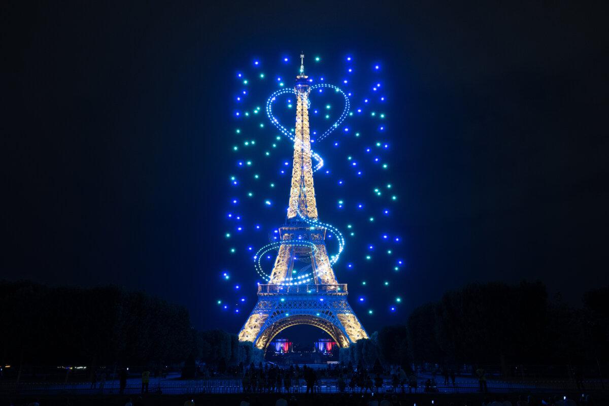 Drones surround the Eiffel Tower and create a heart-shaped formation during the fireworks and drone spectacle in Paris on the eve of France's National Day on July 13, 2026. (David Nivière/Courtesy of France Télévisions)