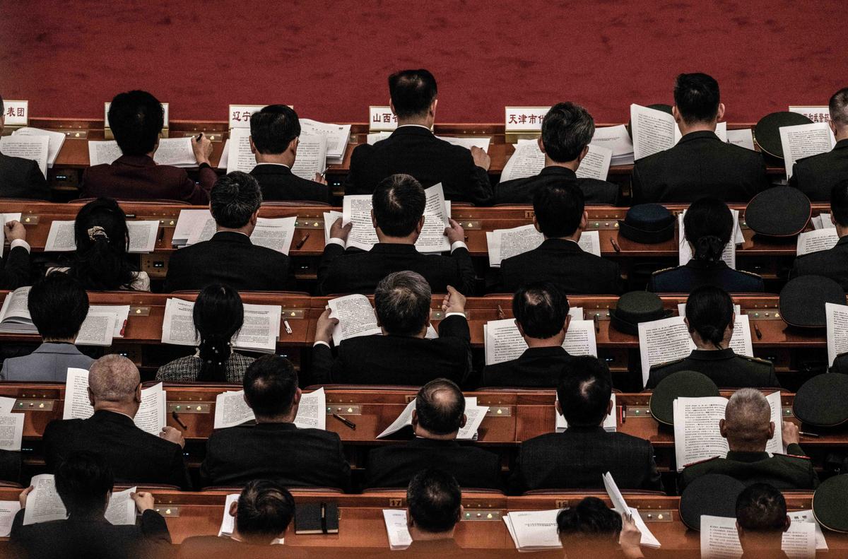 Chinese delegates follow along as they listen to a speech during the opening session of the National People's Congress at the Great Hall of the People in Beijing, China, on March 5, 2026. (Kevin Frayer/Getty Images)