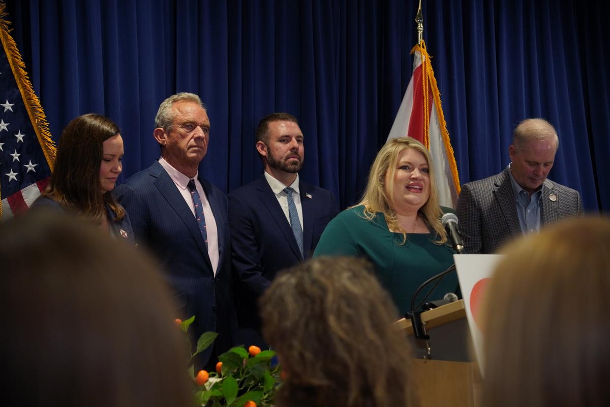 From left to right, Sen. Ashley Moody (R-Fla.), Health and Human Services Secretary Robert F. Kennedy Jr., Acting Food and Drug Administration (FDA) Commissioner Kyle Diamantas, Rep. Kat Cammack (R-Fla.), and Florida Commissioner of Agriculture Wilton Simpson speak at a press conference announcing an FDA rule change for pasteurized orange juice sugar content in Lakeland, Fla., on July 17, 2026. (Jacob Burg/The Epoch Times)